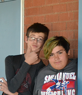 Two students pose together outside