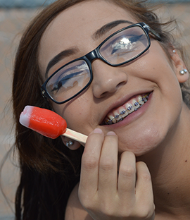 Smiling female student poses with a popsicle